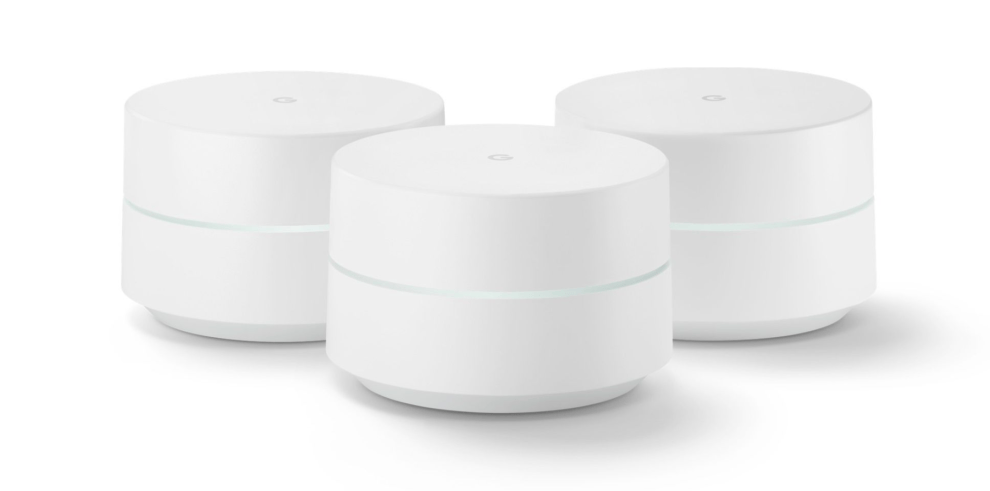 A set of three Google WiFi routers with a solid white light, indicating proper connectivity and operation.